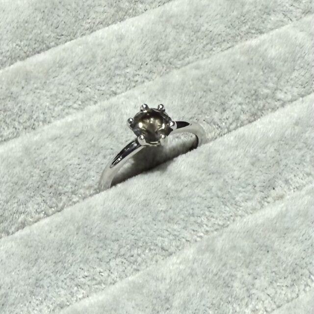 A gold ring set with a very rare grey diamond