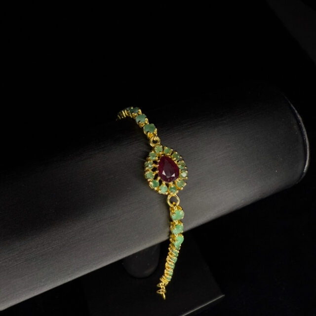 A silver-gilt bracelet set with rubies and emeralds
