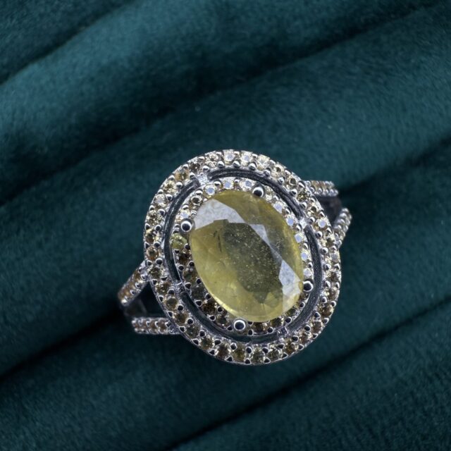 A silver ring with yellow sapphires