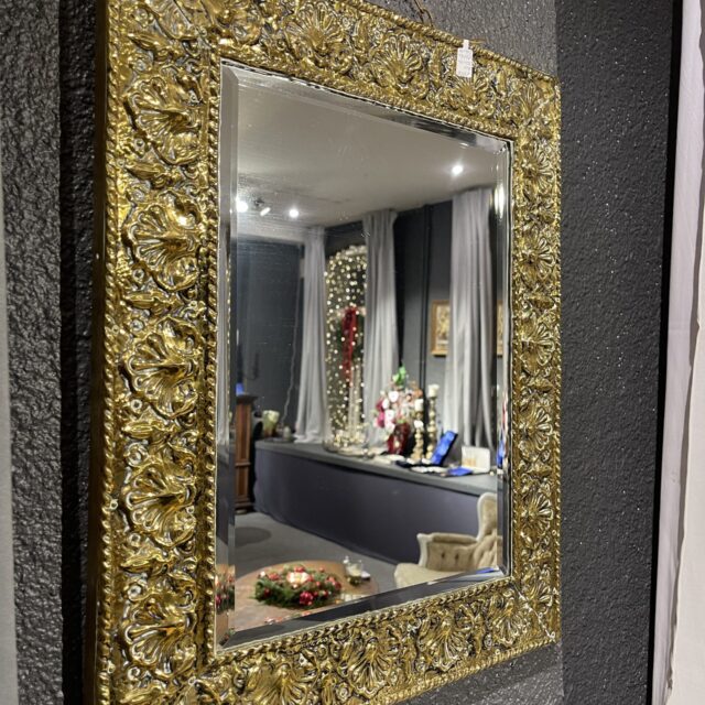 Mirror with a brass frame