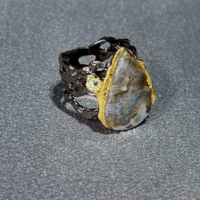 A silver ring with agate and topaz