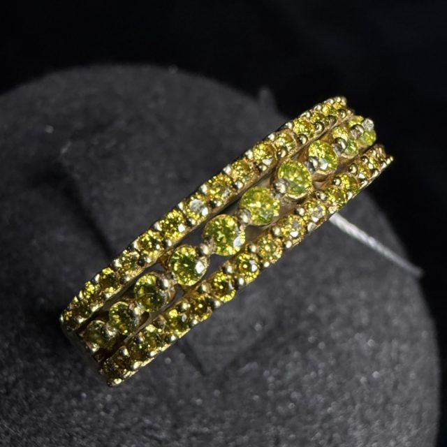 A gold ring set with yellow diamonds